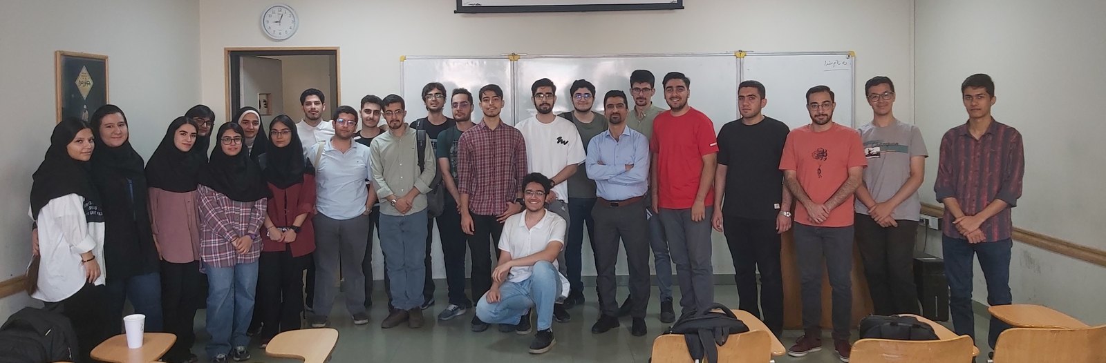 Ahmad Shabani with students in a classroom